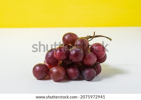 Creative layout made of red grape. Food concept.