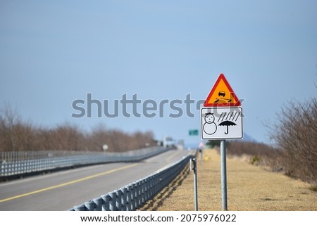 A road traffic sign Be careful of slipping when it snows or rains.