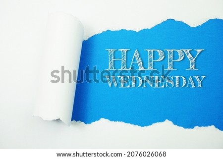 Happy Wednesday word on blue background with paper torn