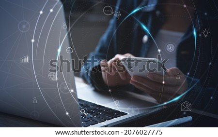 IoT, Internet of Things, online shopping, digital marketing, E-commerce, business and technology concept. Woman using mobile phone and laptop computer fro online shopping and banking via mobile app Royalty-Free Stock Photo #2076027775