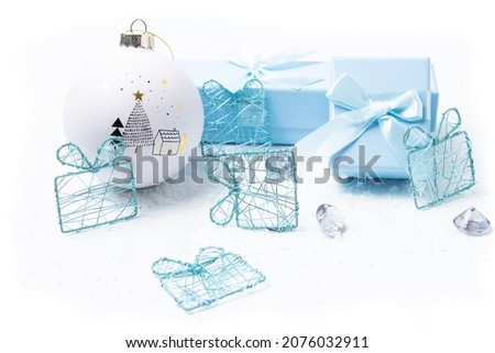 Christmas and newborn motifs on white and light blue snowy background