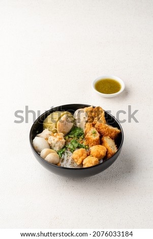 Yong tau foo , yong tau fu or Liong Tahu (In Indonesia). is a Hakka Chinese cuisine consisting primarily of tofu filled with ground meat mixture or fish paste. Royalty-Free Stock Photo #2076033184