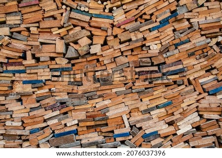 Wall of stacked wood logs for background.