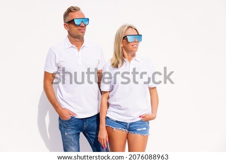 Woman and man wearing blank white polo shirts, mockup for polo shirt design