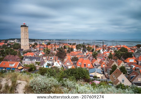 Old lighthouse in a small village on the island Terschelling in the Netherlands - long exposure shot Royalty-Free Stock Photo #207609274