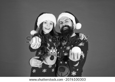 small girl and santa dad. christmas together. happy family playing snowballs in winter. That is just amazing. father and daughter celebrate new year. family holiday party