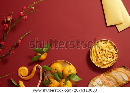 Tet holiday with mandarin orange candy jam , fried potato , flower and ang pao biscuit in golden dish , photography Tet holiday content