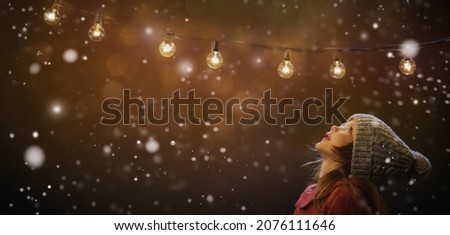 A little girl rests on top at christmas - childhood belief Royalty-Free Stock Photo #2076111646