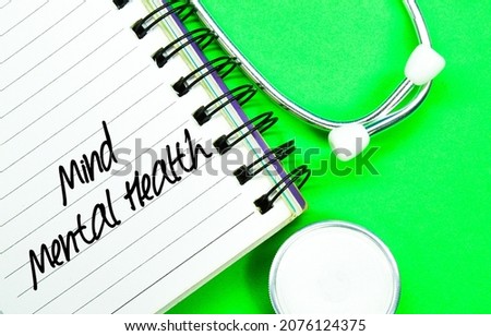 stethoscope and notebook with the words mind mental health
