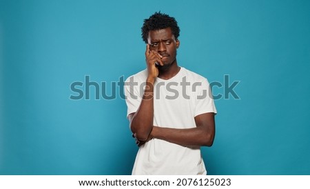 Concentrated man thinking about uncertain idea. Pensive person brainstormind and searching for soltuion, pondering thoughts about desicion. Adult in doubt with contemplation expression Royalty-Free Stock Photo #2076125023