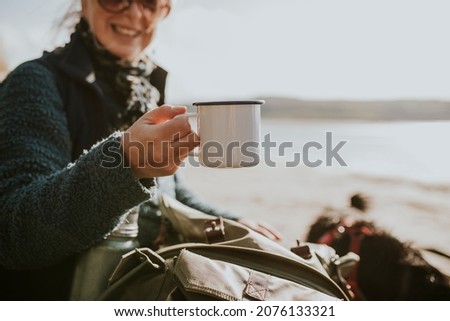 Senior woman camper holding a coffee mug with design space