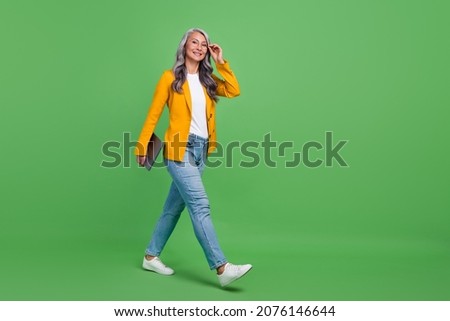 Full body profile side photo of retired woman go agent attorney leader isolated over green color background
