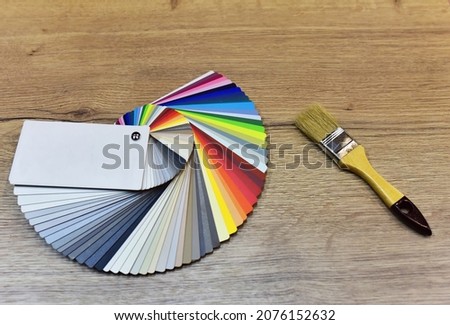 Color palette swatches with paint brush. Palette of different colors and shades on white background. Color catalog for tinting facade and interior paints, painting and for wooden facades in furniture