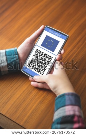 Man holding smartphone with covid 19 vaccine passport. global covid 19 pandemic concept digitally generated video.