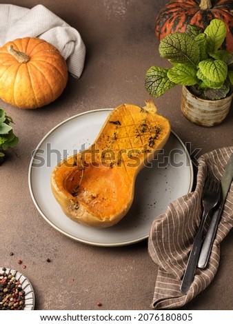 Baked pumpkin half on a plate with thyme