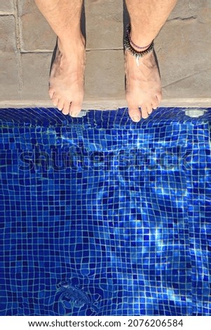 bare feet blue pool outdoor tile 