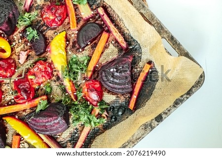 Roasted vegetables beets, tomatoes, peppers, carrots, close up. Vegan recipe baked vegetables background. Healthy food concept
