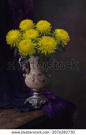 Still life with luxurious bouquet of yellow chrysanthemums