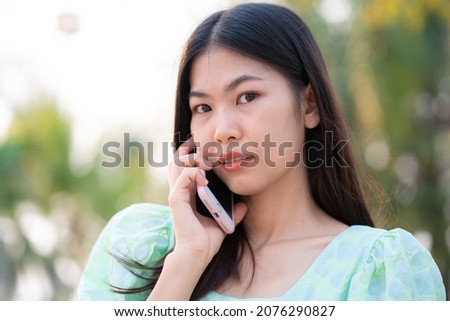 Beautiful asian women use cell phone outdoor park communication people