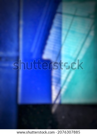 defocused abstract background of blue green and black color composition