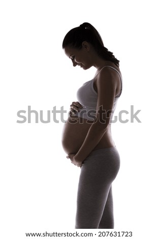 Studio portrait of a beautiful young pregnant woman isolated on white background