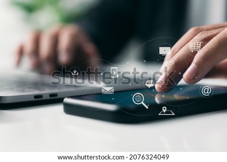 E-commerce, IOT, and digital marketing. The Internet of Things is a concept for online purchasing. Business and technology dashboard. Man using a mobile phone with icons and a Pay Per Click (PPC). Royalty-Free Stock Photo #2076324049