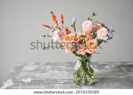 Finished flower arrangement in a vase for home. Flowers bunch, set for interior. Fresh cut flowers for decoration home. European floral shop. Delivery fresh cut flower. Royalty-Free Stock Photo #2076330589