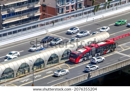 Bus stops by station on overpass with other traffic in Chengdu, second ring road, depiction of the Chengdu Bus Rapid Transit system, Chinese characters translate as bus Royalty-Free Stock Photo #2076355204