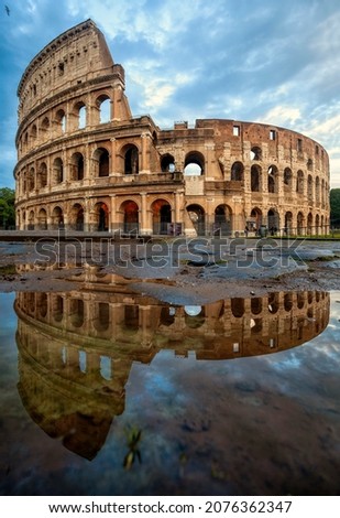 Colosseum morning in Rome, Italy. Exterior of the Rome Colosseum. Colosseum is one of the main attractions of Rome (Roma) and Italy. Rome architecture and landmark. Reflection of Colosseum in water.  Royalty-Free Stock Photo #2076362347