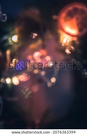 Vintage Christmas lights bokeh background in dark orange purple colors as fairy lights 