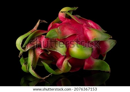 Dragon fruit horizontally rotated on a black background with reflection