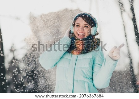 Photo of charming young nice happy lady good mood dance listen music snow fall winter outside outdoors
