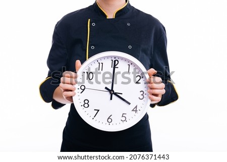 Close up of a woman chef holding a clock, over white background