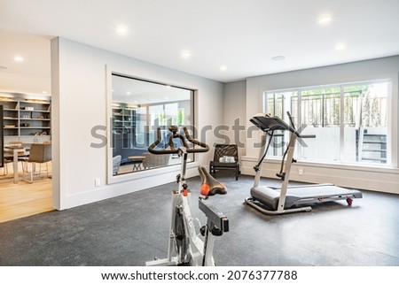 home gym with rubber matt flooring large glass viewing window Royalty-Free Stock Photo #2076377788