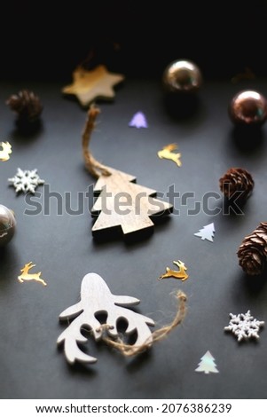 Various Christmas ornaments and colorful sequins on dark background. Selective focus.