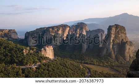 Landscape with monasteries and rock formations in Meteora during sunset, Greece.