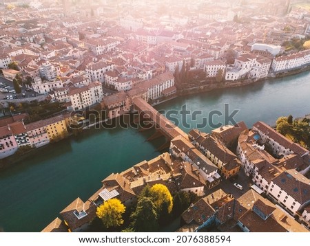 Bassano del Grappa historical bridge panoramic aerial view in a sunny day with flare. Royalty-Free Stock Photo #2076388594
