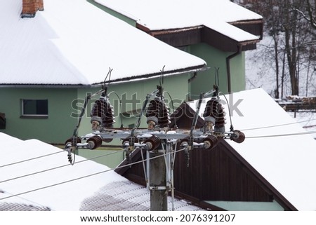 Winter power pole under snow
