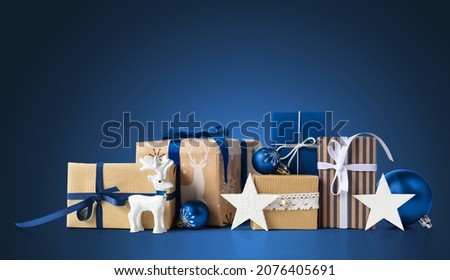 Gift boxes and christmas decorations on blue background