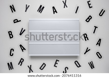 Blank lightbox with letters over white background.