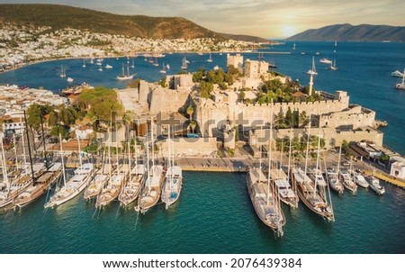 Sunset in yacht port at Castle.  Yachting sunset scene. Yachts in sunset bay. Castle of St. Peter Bodrum Marina, sailing boats and yachts in Bodrum, Turkey Royalty-Free Stock Photo #2076439384