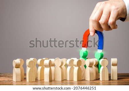 Employer recruits employees with a magnet. Hiring staff from a quality human resource. Professional job candidates. Employment of talented workers. Identifying people with skills, leadership qualities Royalty-Free Stock Photo #2076446251