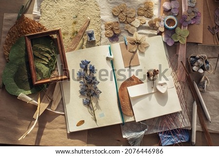 Autumn mood. Reading. An open book with maple leaves. Kraft paper. The envelope. Dry leaves. Herbarium. Royalty-Free Stock Photo #2076446986