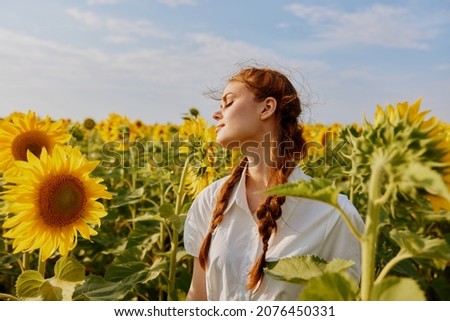 woman with two pigtails in a white dress admires nature unaltered