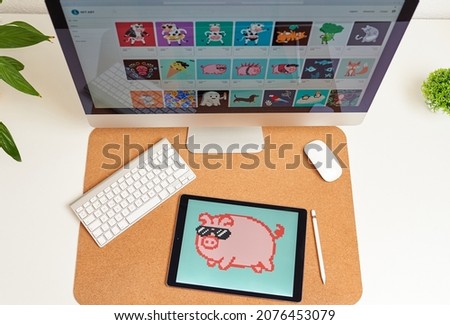 NFT on a digital tablet on a desk illustration of a pig Royalty-Free Stock Photo #2076453079
