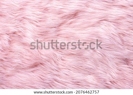 Trendy pink artificial fur texture. Fur pattern top view. Pink fur background. Texture of pink shaggy fur. Wool texture. Flaffy sheepskin close up
