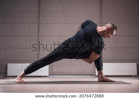 Adult man performs asana exercises. Yoga concept. Sports and healthy lifestyle. Mixed media Royalty-Free Stock Photo #2076472888