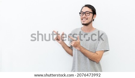 Attractive beautiful positive happy asian man hands point up. Close up portrait asian nerdy man. Handsome nerd asia Japanese guy wearing glasses with big smile isolated on white background.