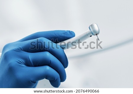 boron machine dental drill in the doctor's hand with water stomatology Royalty-Free Stock Photo #2076490066