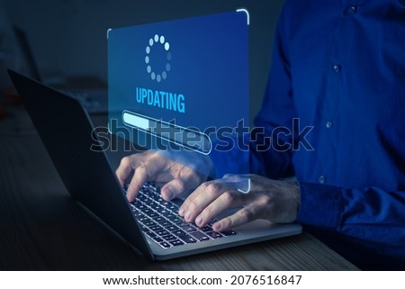 Software update or operating system upgrade to keep the device up to date with added functionality in new version and improve security. Updating progress bar on computer screen. Installing app patch. Royalty-Free Stock Photo #2076516847